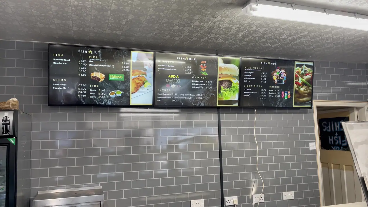 Takeaway menu displayed on wall-mounted digital screens