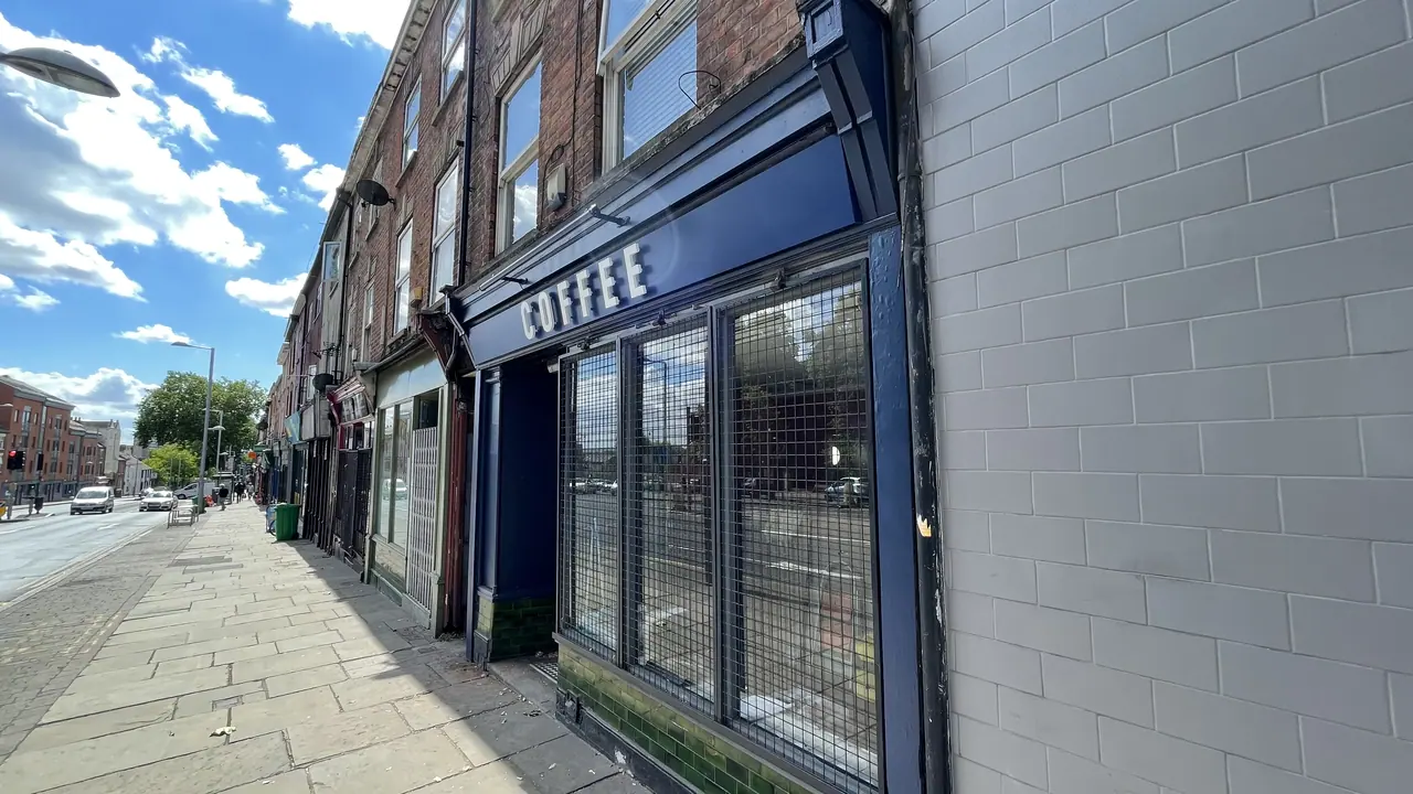 Navy fascia sign reading COFFEE on a high street shop