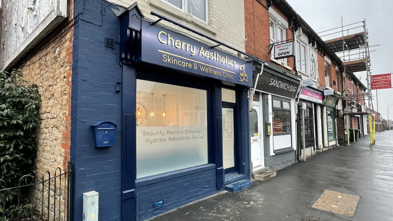 Navy painted shop front with raised lettering on the fascia